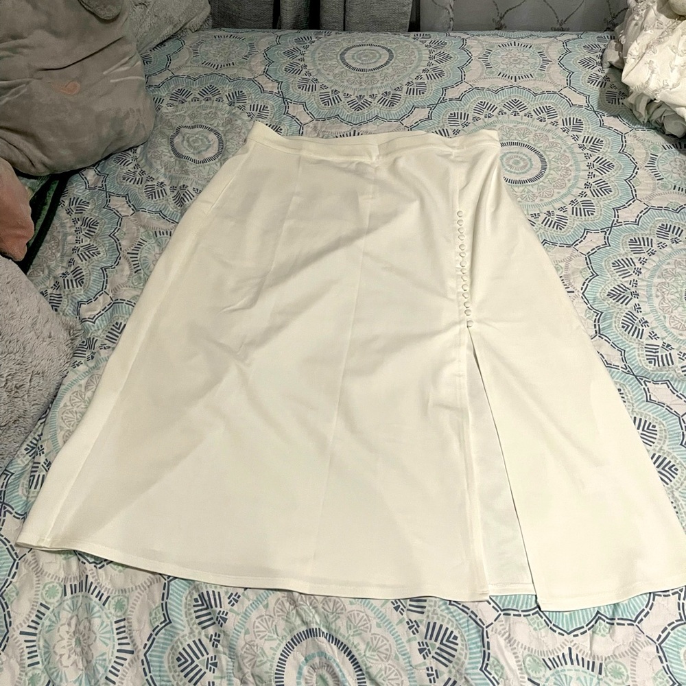 A white skirt with a slit